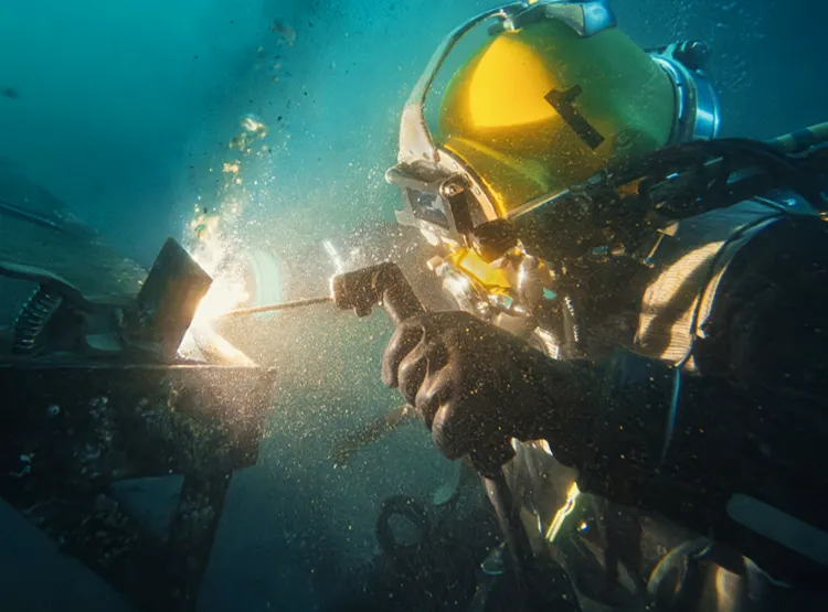 Photo of a scuba diver welding underwater