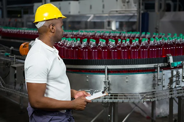 male-worker-inspecting-bottles-juice-factory Placeholder image for 600px x 400px